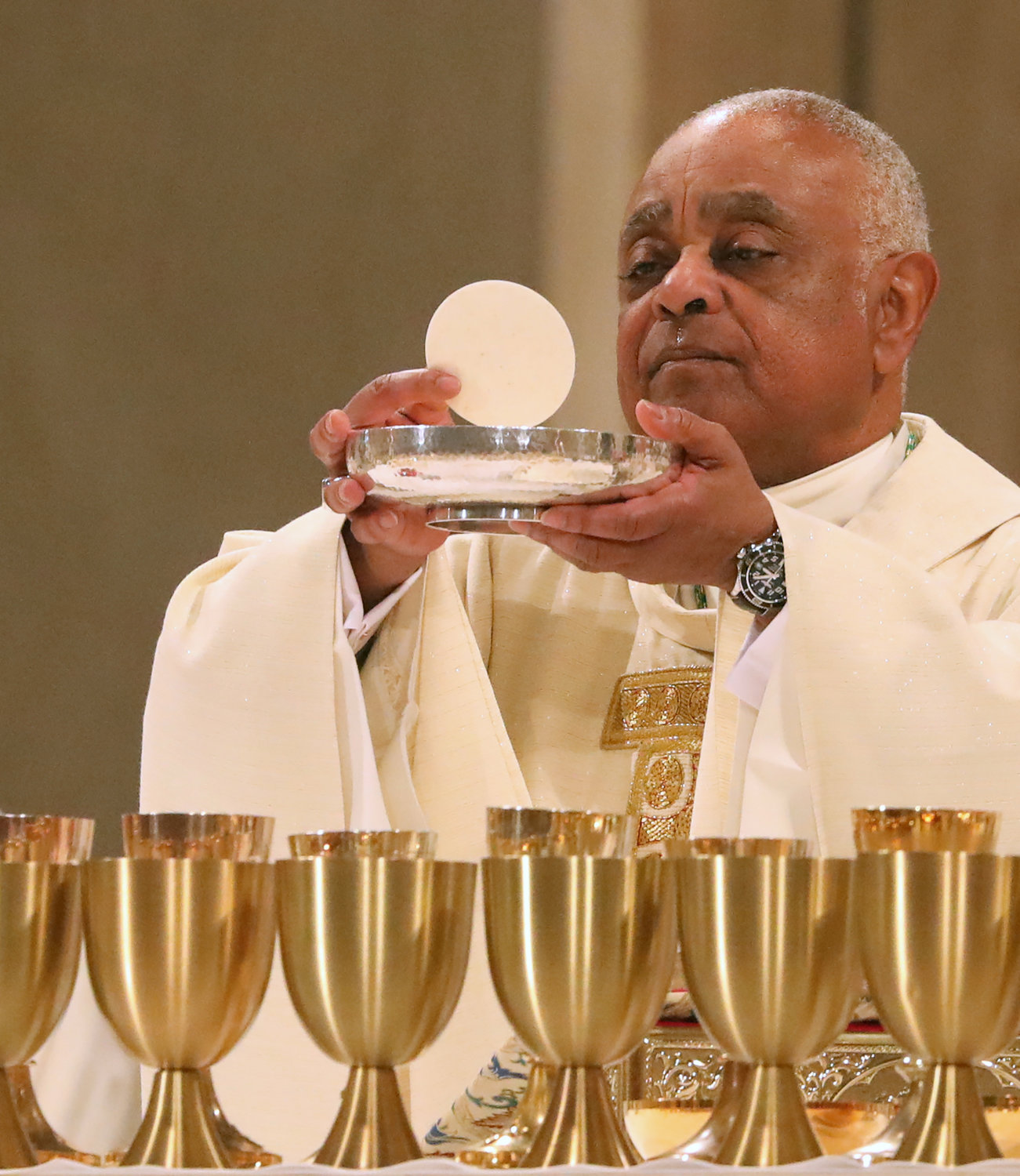 Archbishop Wilton D. Gregory displays the papal bull on his appointment to Washington during his installation Mass at the Basilica of the National Shrine of the Immaculate Conception in Washington May 21, 2019.